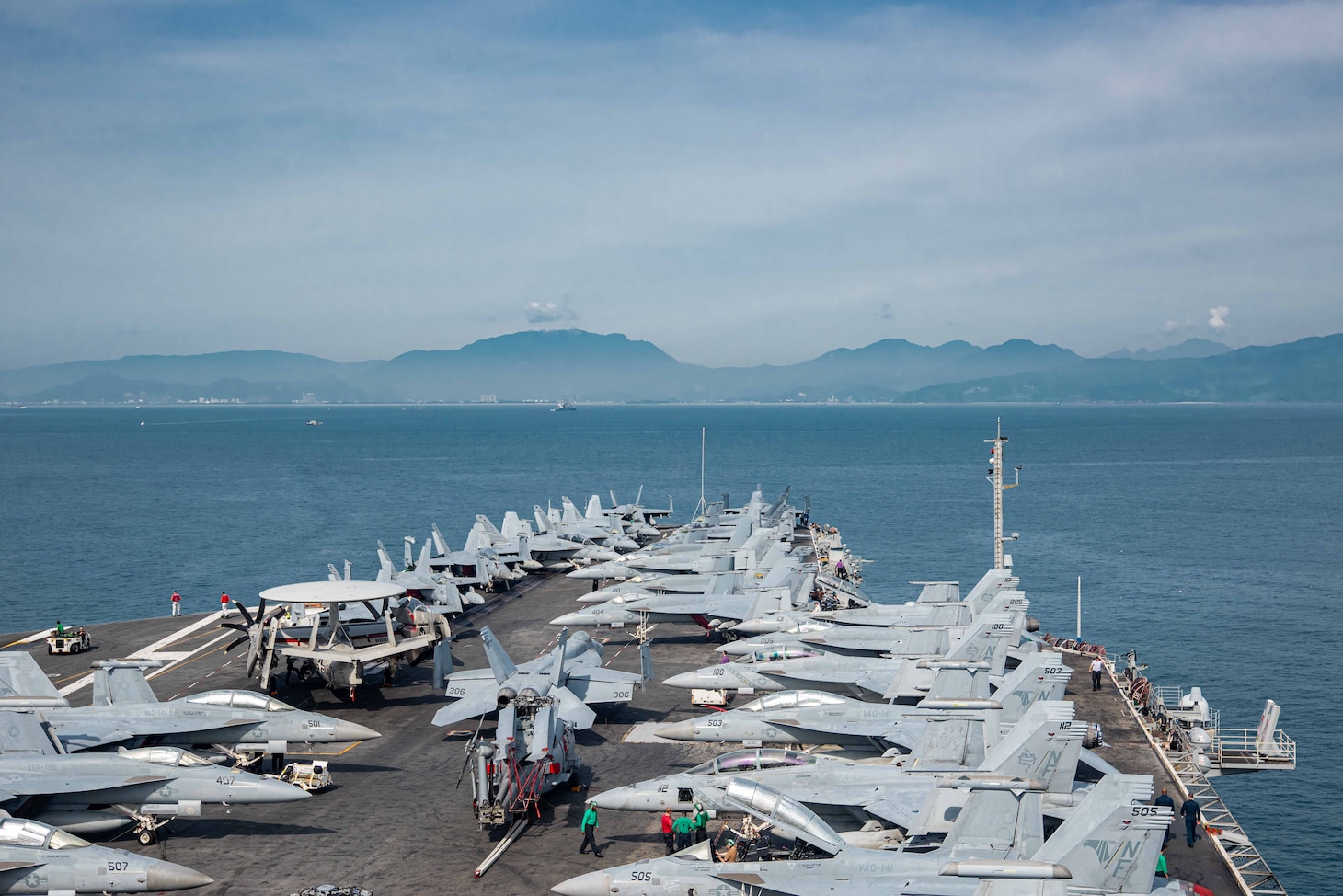 230625-N-OE145-1001 DA NANG, Vietnam (June 25, 2023) The U.S. Navy’s only forward-deployed aircraft carrier, USS Ronald Reagan (CVN 76), approaches Da Nang, Vietnam, for a scheduled port visit June 25, 2023. Ronald Reagan, the flagship of Carrier Strike Group 5, provides a combat-ready force that protects and defends the United States, and supports alliances, partnerships and collective maritime interests in the Indo-Pacific region. (U.S. Navy photo by Mass Communication 3rd Class Jordan Brown)