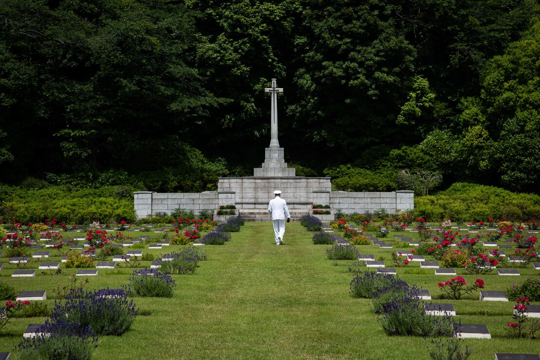 A U.S. Sailor walks through the British Commonwealth War Graves Commission Cemetery in Yokohama, Japan on Memorial Day 2023.