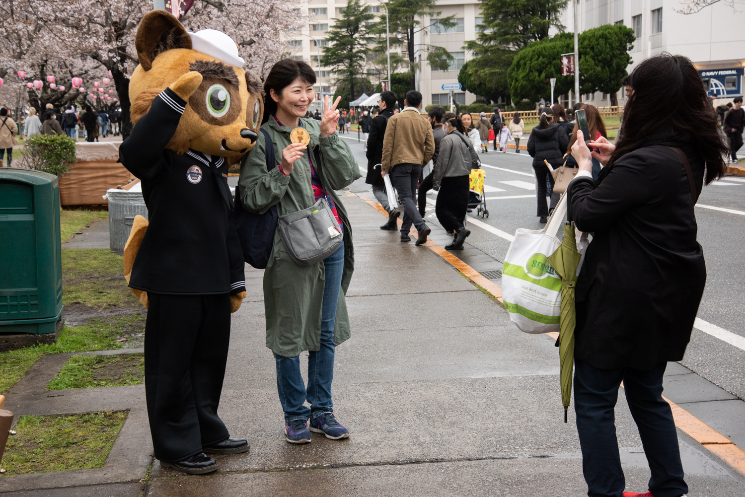 Japanese community members poses for a photo with Commander, Fleet Activities Yokosuka’s official mascot, Yoko-Pon, during the 27th annual Spring Festival..