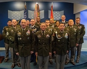 Group of people in U.S. Army uniform pose for photo.