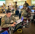Soldiers in front of computers