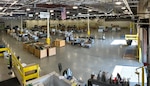 A large warehouse with items neatly stacked in lines so people and equipment can move between the piles of property. the space is well lit, organized and clean.
