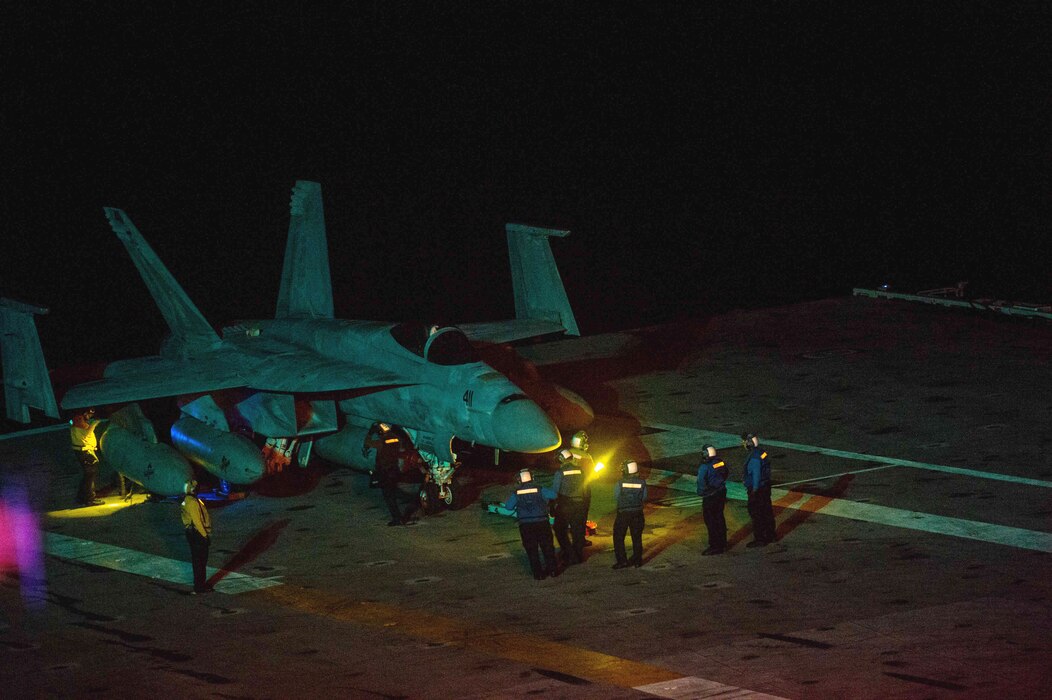 Sailors maneuver an F/A-18F Super Hornet aboard USS Dwight D. Eisenhower (CVN 69).