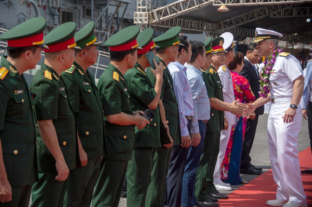 Sailors from the Vietnam People's Navy welcome Rear Adm. Pat Hannifin during a welcome ceremony for USS Ronald Reagan (CVN 76) in Da Nang, Vietnam.