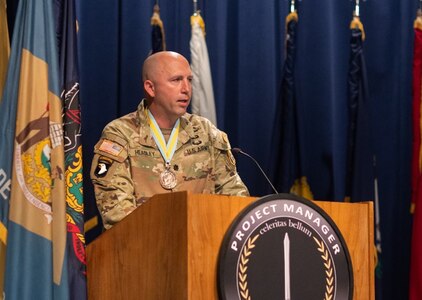 Lt. Col. Joshua Headley, former Product Manager, Next Generation Weapons, expresses his feelings at a recent consolidation ceremony at Picatinny Arsenal, New Jersey May 24, 2023. The event officially established the consolidation of the Product Manager Next Generation Weapons Office and the Product Manager Individual Weapons Office into a single Product Management Office.