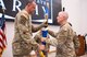 Lt. Col. Christian Hasbach accepts the Army Acquisition Corps flag from Col. Anthony Gibbs, Project Manager Soldier Warrior, during a Product Manager Soldier Maneuver Sensors (PdM SMS) change of charter ceremony held on Fort Belvoir, June 22. Hasbach assumed leadership as product manager from Lt. Col. Melissa Johnson, accepting responsibility for the total life cycle management of SMS programs. PdM SMS is a product management office within the Program Executive Office, Soldier (PEO Soldier) portfolio, with a mission to rapidly deliver integrated sensors that enable the Soldier system to detect and engage first against all threats. (U.S. Army Photo by Jason Amadi, PEO Soldier Public Affairs)