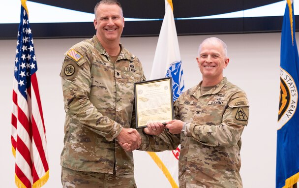 Lt. Col. Christian Hasbach receives the Product Manager Soldier Maneuver Sensors (PdM SMS) charter from Col. Anthony Gibbs, Project Manager Soldier Warrior, during a change of charter ceremony held on Fort Belvoir, June 22. Hasbach assumed leadership as product manager from Lt. Col. Melissa Johnson, accepting responsibility for the total life cycle management of SMS programs. PdM SMS is a product management office within the Program Executive Office, Soldier (PEO Soldier) portfolio, with a mission to rapidly deliver integrated sensors that enable the Soldier system to detect and engage first against all threats. (U.S. Army Photo by Jason Amadi, PEO Soldier Public Affairs)