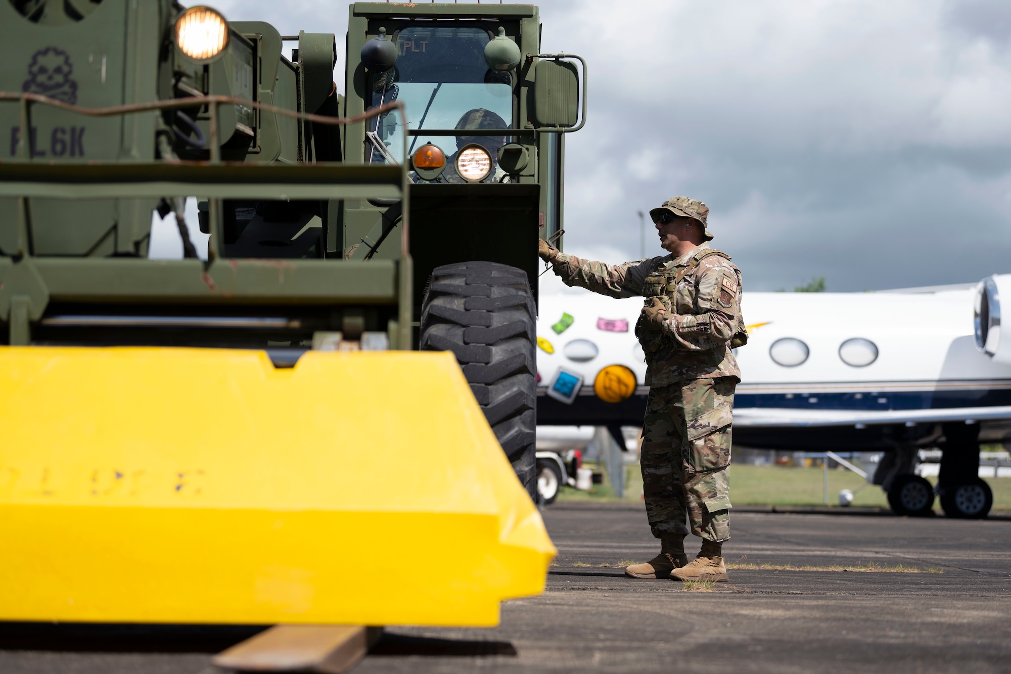 U.S. Air Force Master Sgt. Luis Ocasio, an air transportation specialist assigned to the 156th Tactical Advisory Squadron, guides U.S. Army Sgt. Xavier Cotto, systems operations, assigned to the 346th HHD, in the operation of a forklift during the Advisor Edge exercise at Roosevelt Roads, Ceiba, Puerto Rico, June 8, 2023. Advisor Edge was a multi-unit exercise with the integration of government agencies, where participant units tested air advising skills and strengthened partnerships through unique challenges, allowing burden sharing in combat with partner nations. (U.S. Air National Guard photo by Master Sgt. Rafael D. Rosa)