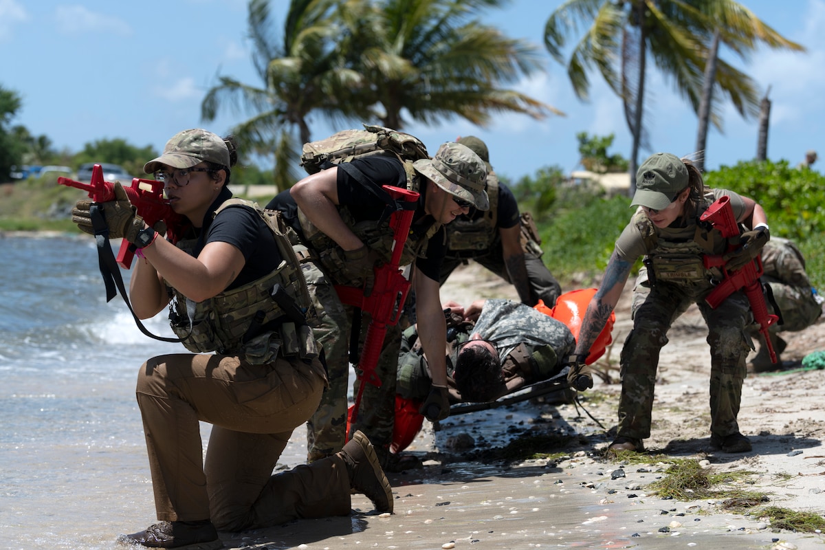 U.S. Airmen assigned to the 156th Security Operations Squadron prepare to carry a simulated distressed person to receive medical care during the Advisor Edge exercise at Roosevelt Roads, Ceiba, Puerto Rico, June 8, 2023.