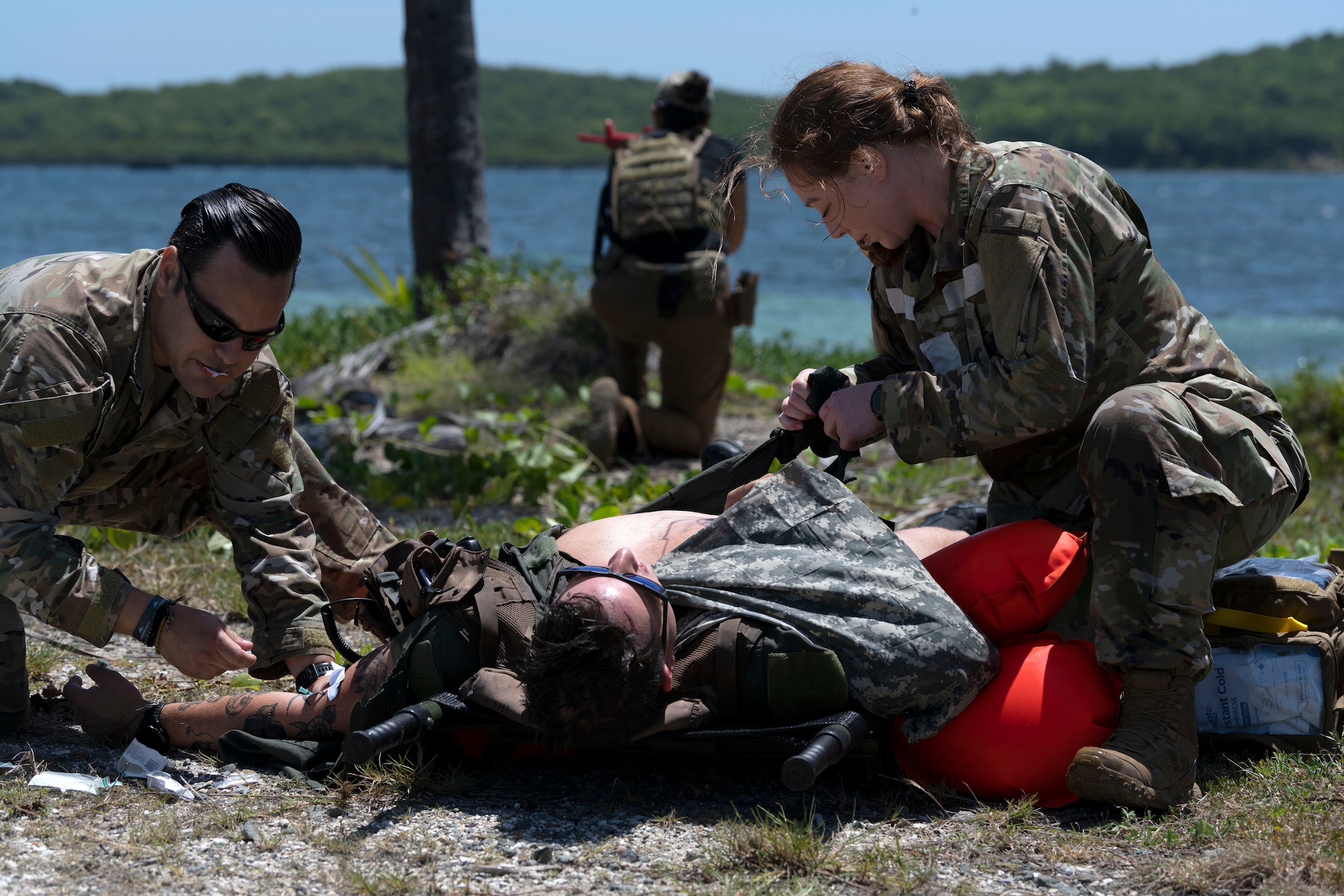 U.S. Air Force Senior Airman Ben Leveillee, a survival, evasion, resistance and escape specialist assigned to the 60th Operations Support Squadron, receives medical care during the Advisor Edge exercise at Roosevelt Roads, Ceiba, Puerto Rico, June 8, 2023. Advisor Edge was a multi-unit exercise with the integration of government agencies, where participant units tested air advising skills and strengthened partnerships through unique challenges, allowing burden sharing in combat with partner nations. (U.S. Air National Guard photo by Master Sgt. Rafael D. Rosa)