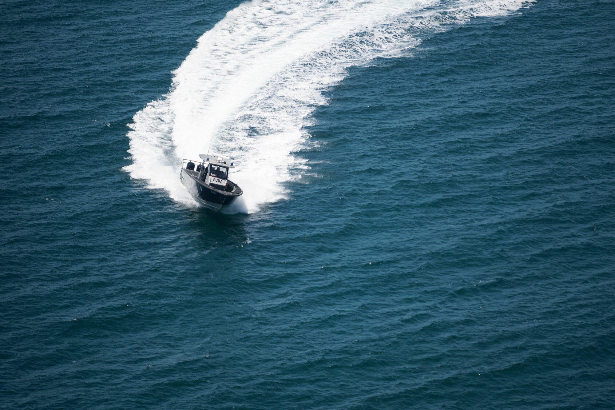 A boat assigned to the Puerto Rico Police Department, Unidad Marítima, Fuerzas Unidas de Rápida Acción, navigates during the Advisor Edge exercise at Roosevelt Roads, Ceiba, Puerto Rico, June 8, 2023. Advisor Edge was a multi-unit exercise with the integration of government agencies, where participant units tested air advising skills and strengthened partnerships through unique challenges, allowing burden sharing in combat with partner nations. (U.S. Air National Guard photo by Airman 1st Class Gisselle Toro Caraballo)