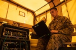 U.S. Marine Corps Cpl. Alan Martinezbenegas, a satellite transmissions system operator with 7th Communication Battalion, III Marine Expeditionary Force Information Group, monitors network status during Exercise Vanguard on Camp Hansen, Okinawa, Japan, June 8, 2023. III MIG functions as the vanguard of III MEF, operating in the Indo-Pacific regions information environment, and supports Marine Air Ground Task Force operations with communications, intelligence, and supporting arms liaison capabilities.