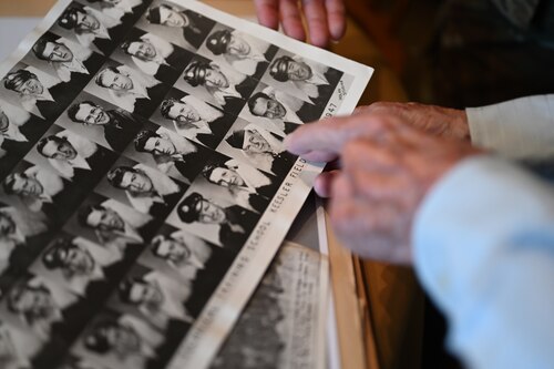 Image of man pointing to photo