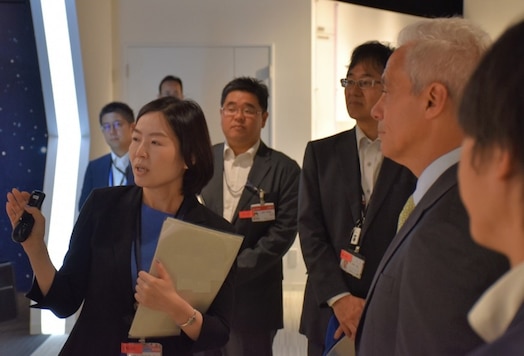  Ms. Asako Ueno, executive director, Quasi-Zenith Satellite System, Japanese National Space Policy Secretariat, Cabinet Office, briefs U.S. Ambassador to Japan, Rahm Emanuel, regarding the status of the Quasi-Zenith Satellite System Hosted Payload program, a pathfinding national security space cooperation initiative between the U.S. and Japan. Photo Credit: Provided by Government of Japan
