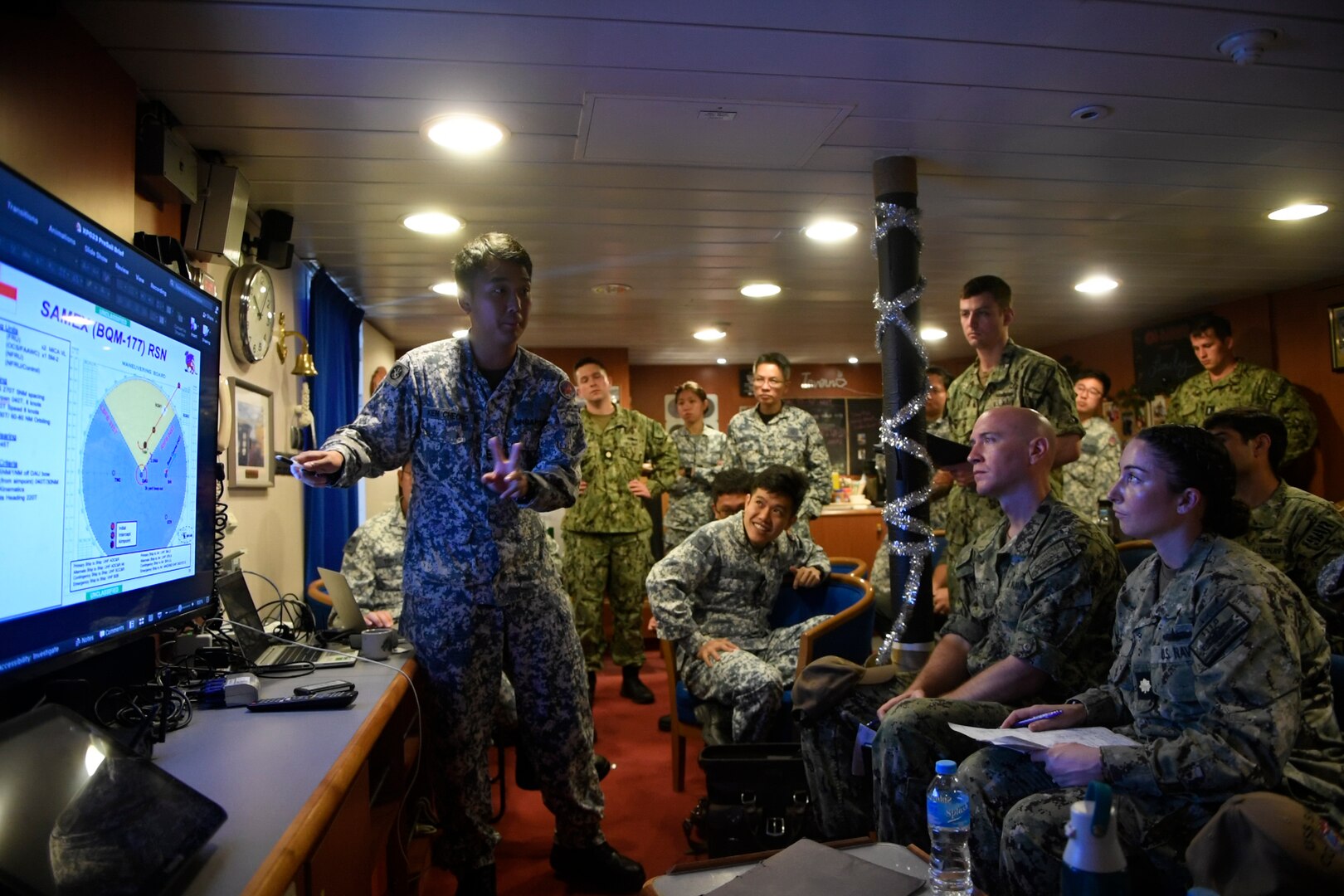 SANTA RITA, Guam, (June 19, 2023) – U.S. and Singaporean Sailors participate in operational brief aboard the Formidable-class stealth frigate RSS Tenacious (71), during Exercise Pacific Griffin 2023. Pacific Griffin 2023 is a biennial maritime exercise between the U.S. and Republic of Singapore. Conducted in the waters near Guam, the two navies enhance combined maritime proficiency while strengthening relationships during two weeks of dynamic training evolutions ashore and at sea. USS Manchester (LCS 14), part of Destroyer Squadron 7, is on a rotational deployment operating in the U.S. 7TH Fleet area of operations to enhance interoperability with Allies and partners and serve as a ready-response force in support of a free and open Indo-Pacific region. (U.S. Navy photo by Mass Communication Specialist 2nd Class Christopher Thomas)