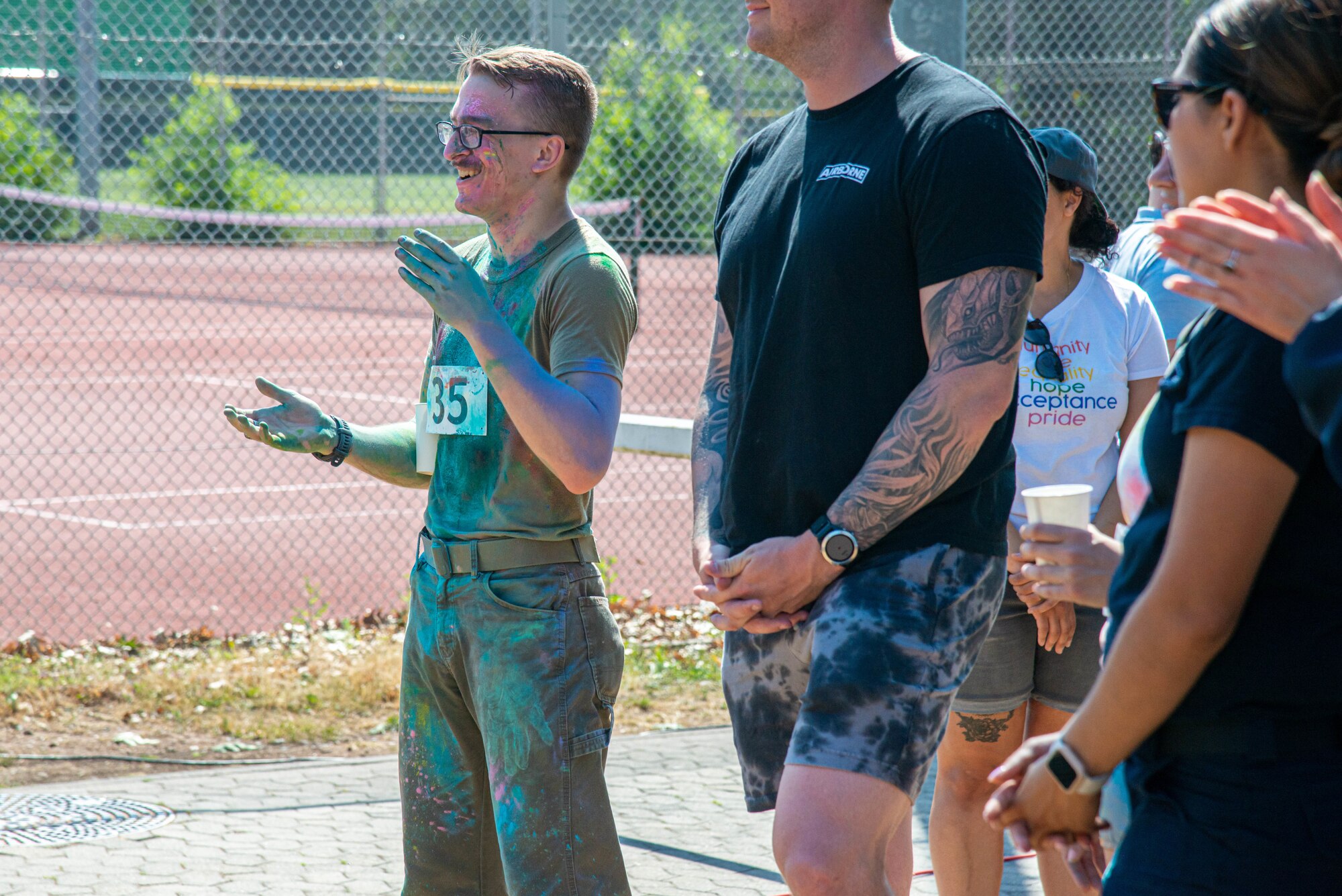 Airman claps for the winners of the color run
