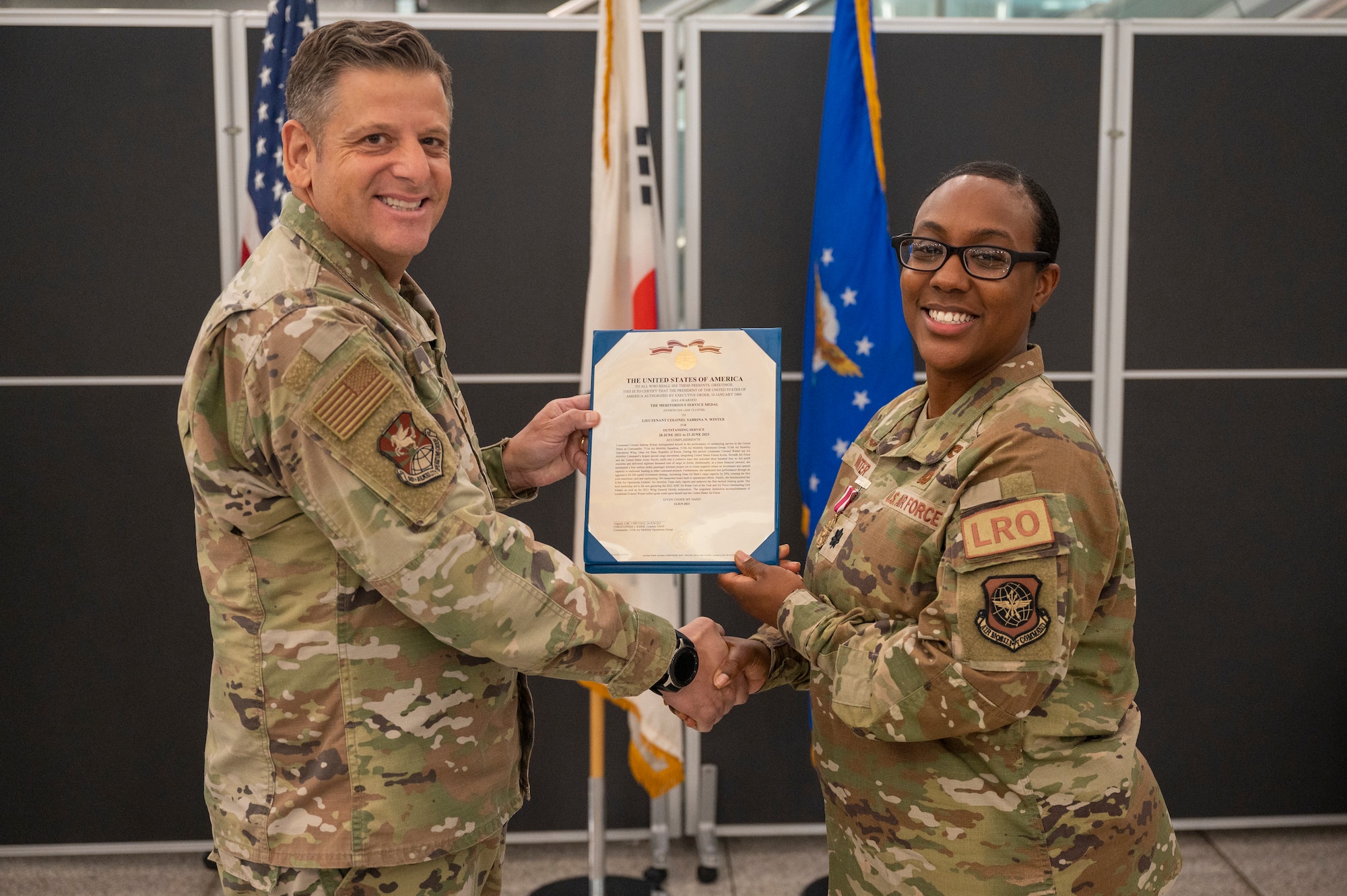 U.S. Air Force Col. Christopher Kiser, left, 515th Air Mobility Operations Group commander, presents a Meritorious Service Medal to Lt. Col. Sabrina Winter, 731st Air Mobility Squadron outgoing commander, at Osan Air Base, Republic of Korea, June 23, 2023. The MSM is a military decoration awarded by various branches of the Armed Forces to recognize distinguished or outstanding meritorious service. (U.S. Air Force photo by Senior Airman Aaron Edwards)