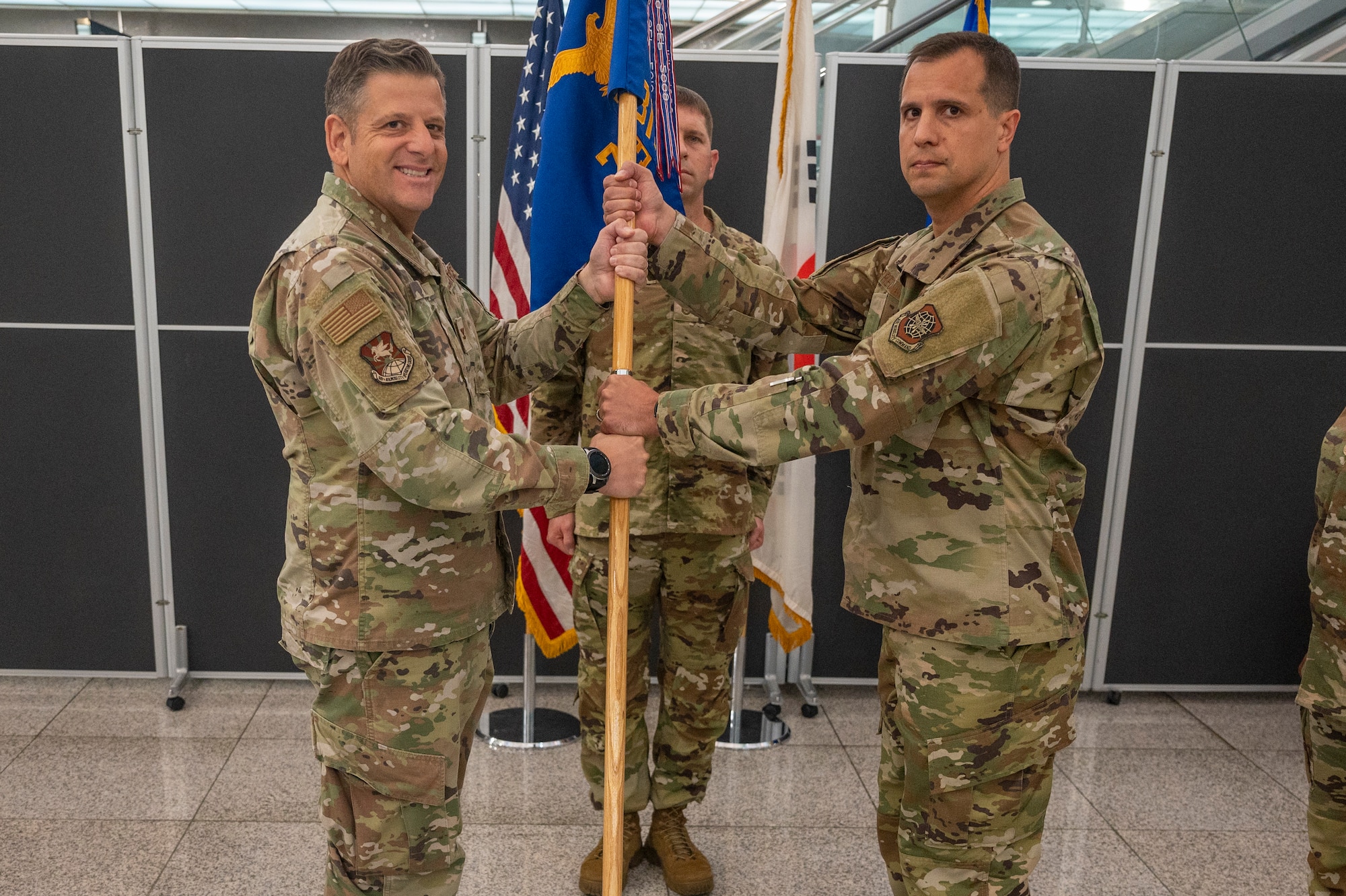 U.S. Air Force Col. Christopher Kiser, left, 515th Air Mobility Operations Group commander, presents the guidon to Lt. Col. Luke Berreckman, 731st Air Mobility Squadron incoming commander, as a symbol of his taking command at Osan Air Base, Republic of Korea, June 23, 2023. Prior to taking command, Berreckman served as the nuclear operations branch chief at headquarters, Air Mobility Command Inspector General Nuclear Division.  (U.S. Air Force photo by Senior Airman Aaron Edwards)
