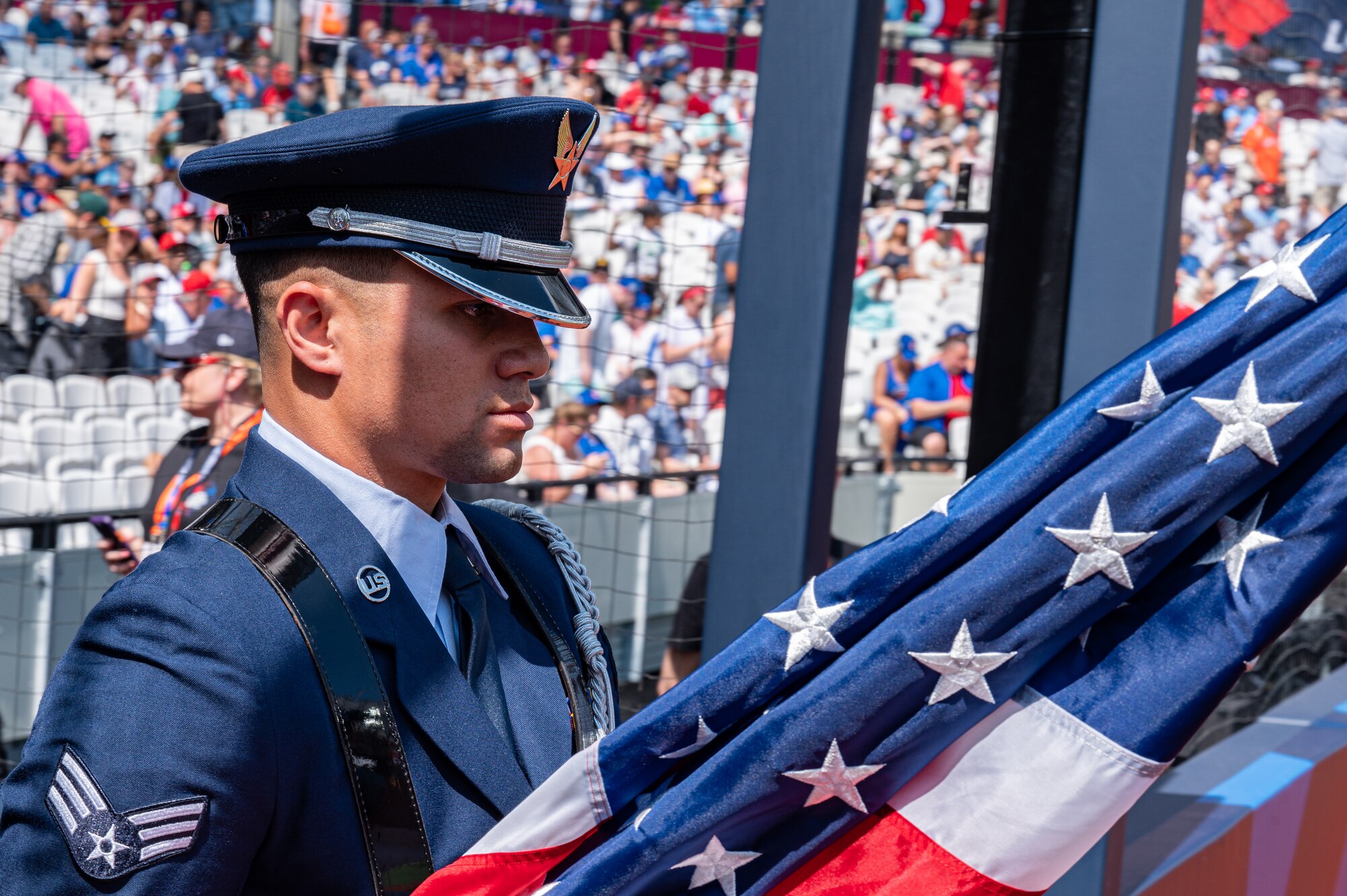 U.S. Air Force Senior Airman Cristian Lugo Rodriguez, 100th Air Refueling Wing honor guardsman, marches onto the field during the pre-game ceremony at London Stadium, England, June 25, 2023.