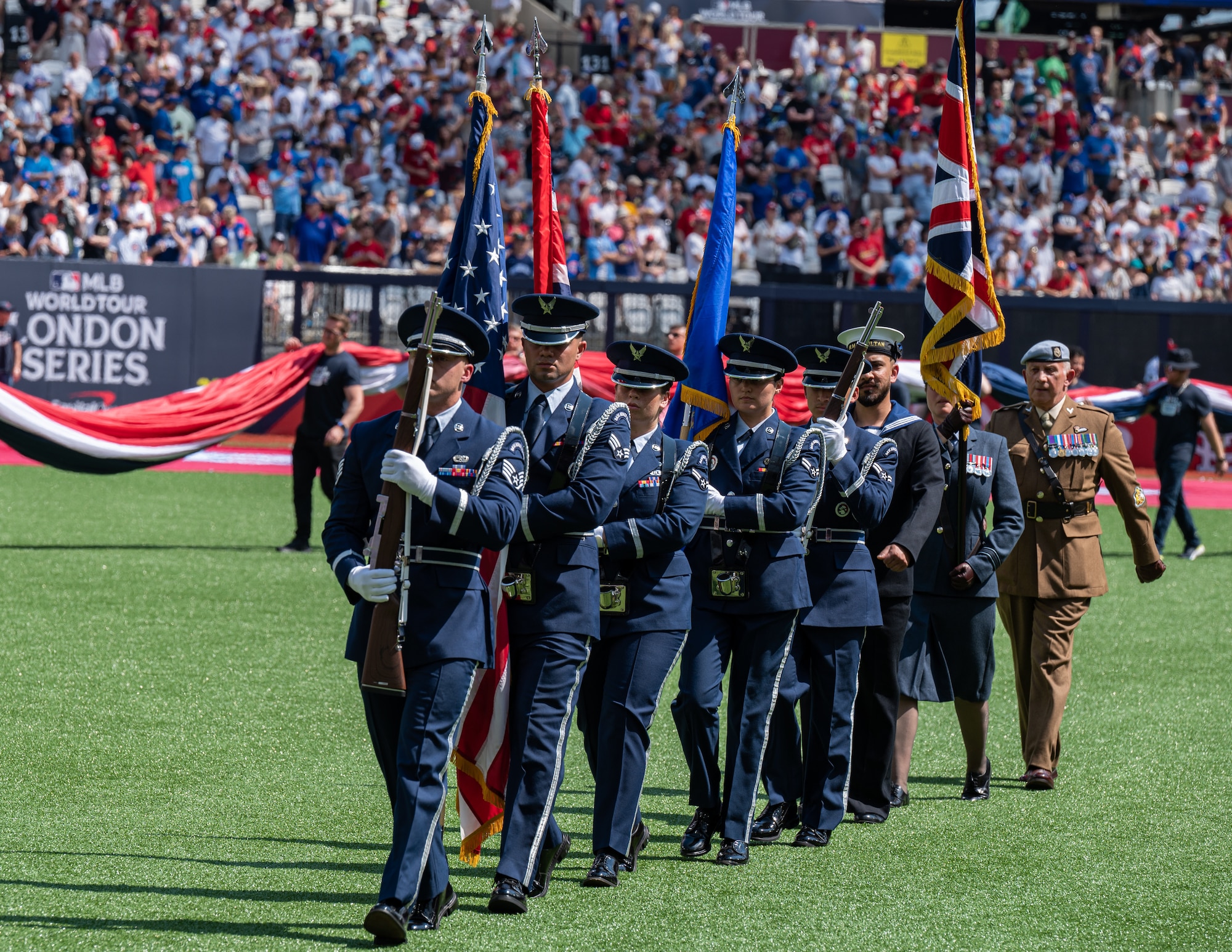 U.S. Air Force Airmen assigned to the 100th Air Refueling Wing honor guard, march off the field following the presentation of the colors during the pre-game ceremony at London Stadium, England, June 25, 2023.
