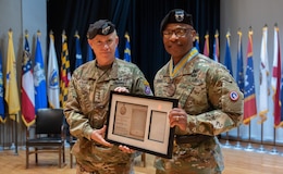 Lt. Gen. Patrick Frank, commanding general, U.S. Army Central (Left), awards the Order of Saint Maurice to Maj. Gen. Michel M. Russell Sr., outgoing commanding general, 1st Theater Sustainment Command (Right), during a change of command ceremony on Fort Knox, Kentucky, June 23, 2023. The Order of Saint Maurice is awarded by the National Infantry Association and the Chief of Infantry to recognize the significant contributions made by Infantrymen, Infantry supporters, and their spouses.