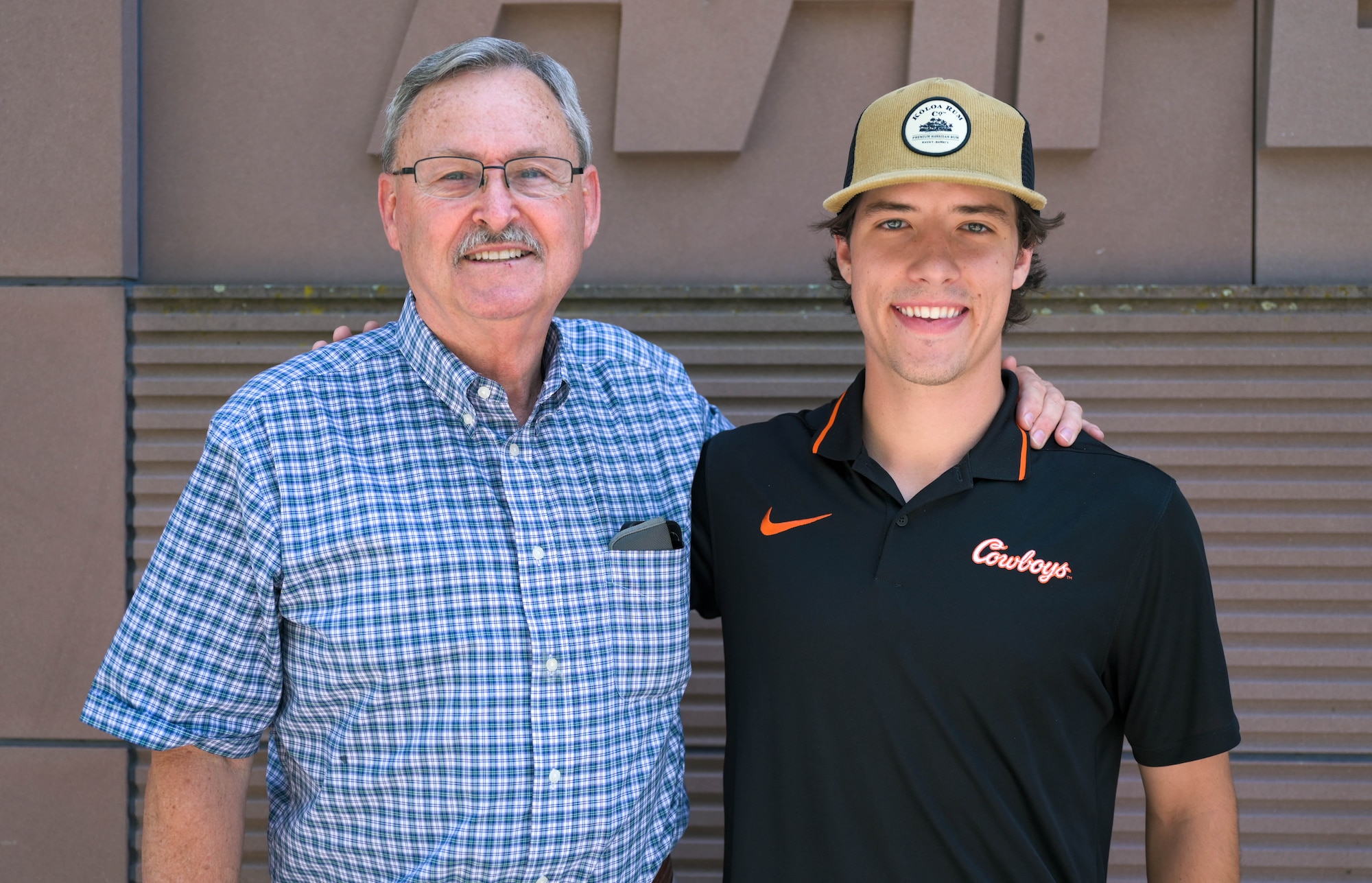 Steven Howe, former Kaiserslautern High School student, stands with his grandson Mark Sesholtz outside of the Kaiserslautern Military Community Center on Ramstein Air Base, Germany, June 20, 2023. Howe experienced the military lifestyle throughout his father's Air Force career and lived in Ramstein, Germany from 1965-1968. Howe has traveled to Europe several times since his family moved back to the United States and he looks fondly on his time spent here. (U.S. Air Force photo by Airman 1st Class Kaitlyn Oiler)