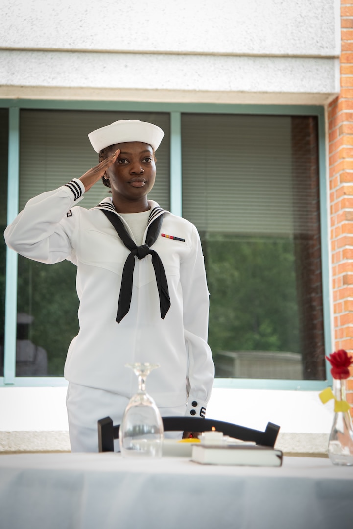 A Navy Hospital Corpsmen serving aboard Marine Corps Air Station Cherry Point salutes while participating in a Missing Man Table and Honors Ceremony on Friday, June 16, 2023.  The ceremony was part of the installation’s celebration of the 125th Birthday of the Navy Hospital Corpsman.