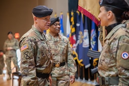 Lt. Gen. Patrick Frank, commanding general, U.S. Army Central (Left), speaks with Soldiers of the 1st Theater Sustainment Command Color Guard, as Maj. Gen. Michel M. Russell Sr., outgoing commanding general, 1st Theater Sustainment Command (Center) looks on, during a change of command ceremony on Fort Knox, Kentucky, June 23, 2023. Russell relinquished command after two years leading the First Team and more than 39 total years of U.S. Army service.