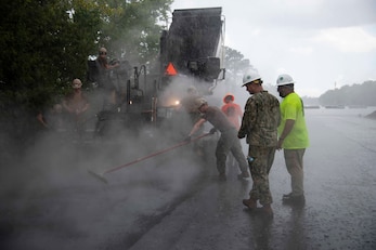 Seabees, assigned to Naval Mobile Construction Battalion 133 (NMCB 133), work in tandem with civilian contractors to resurface a retired airfield on Naval Air Station Joint Reserve Base, New Orleans.