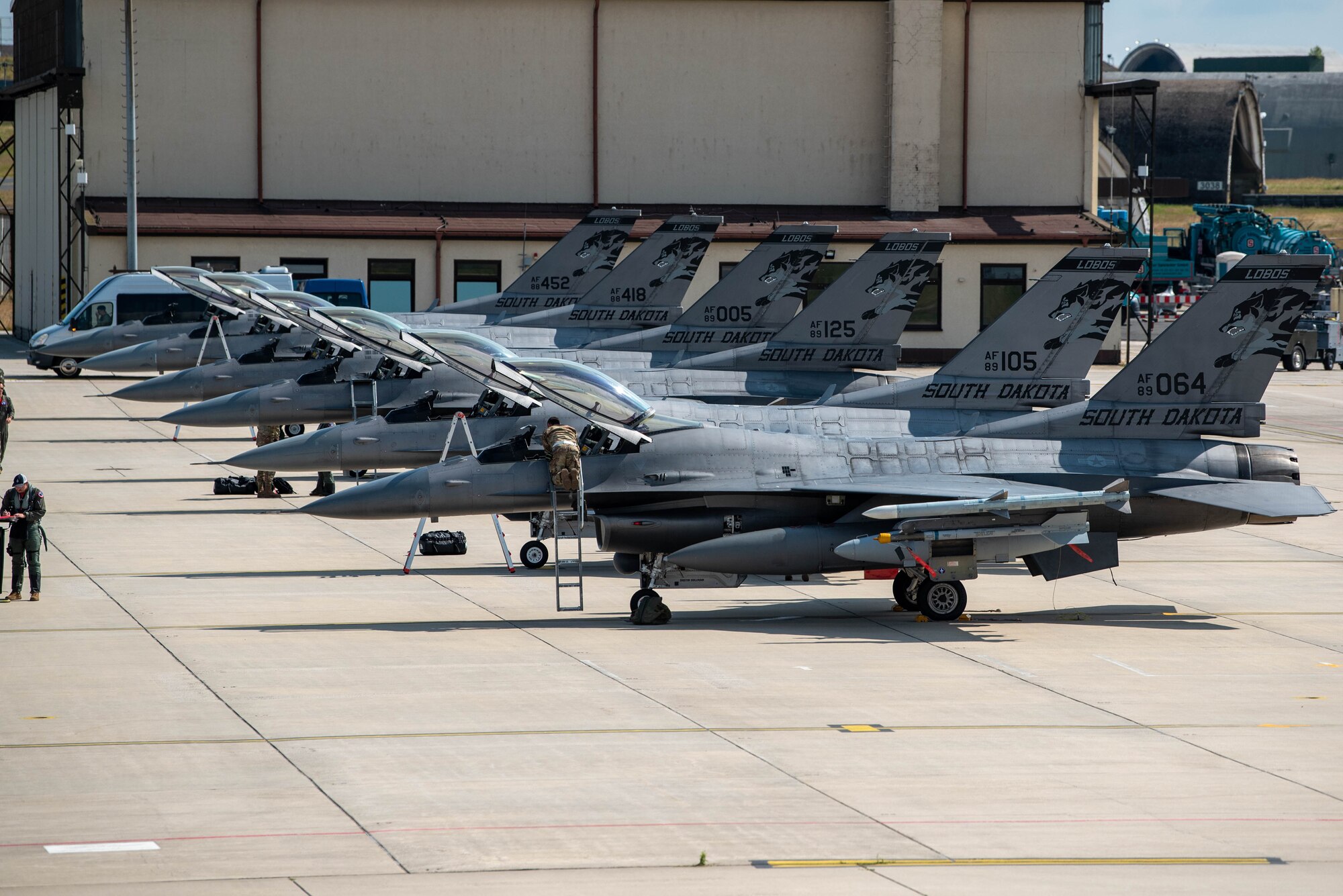 U.S. F-16 Fighting Falcon fighter aircraft, receive post-flight checks after landing at Spangdahlem Air Base, Germany.