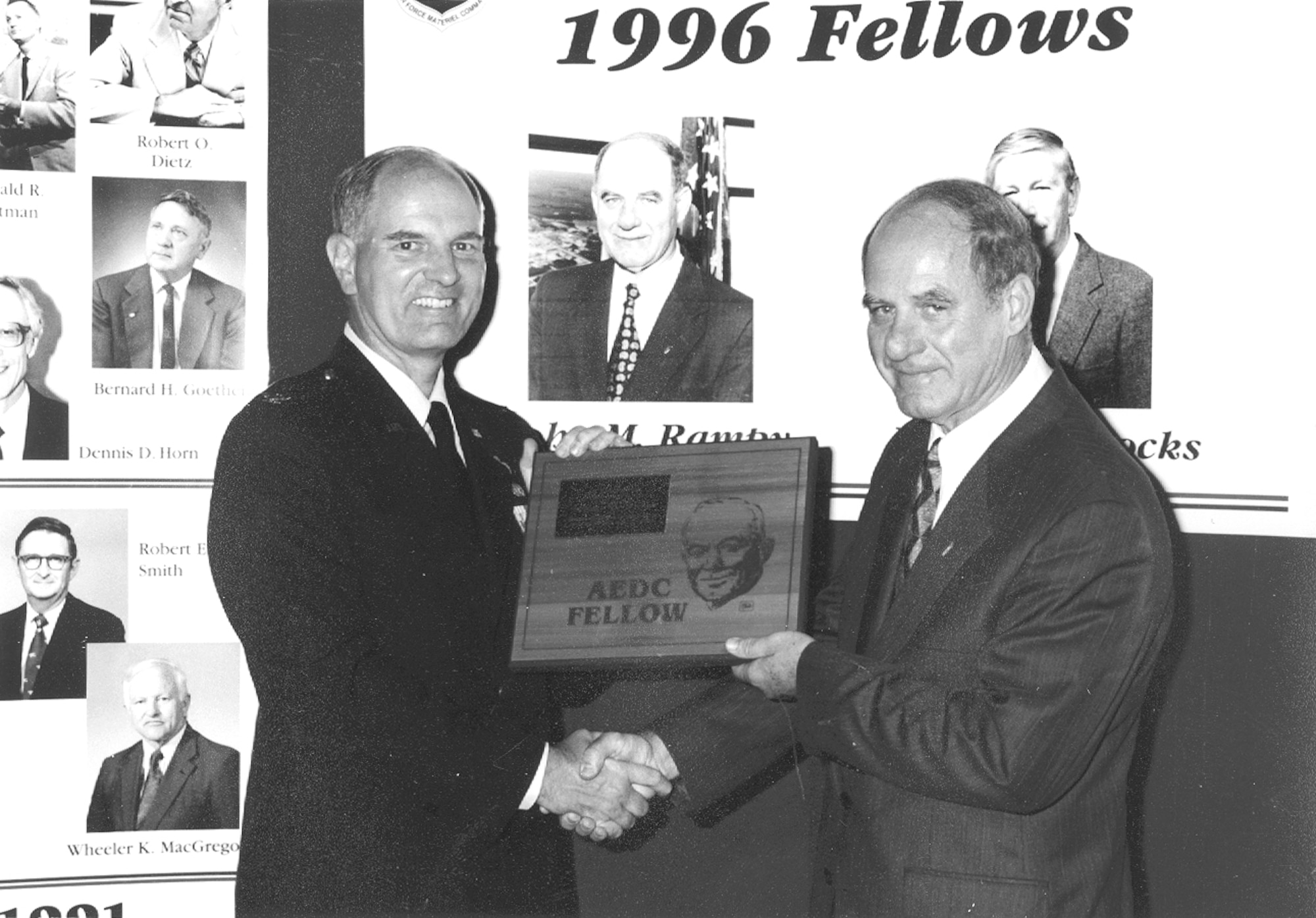 John Rampy, then-executive director of Arnold Engineering Development Complex, right, receives a plaque commemorating his selection as an AEDC Fellow from then-AEDC Commander Brig. Gen. Michael Wiedemer in 1996. (U.S. Air Force photo)