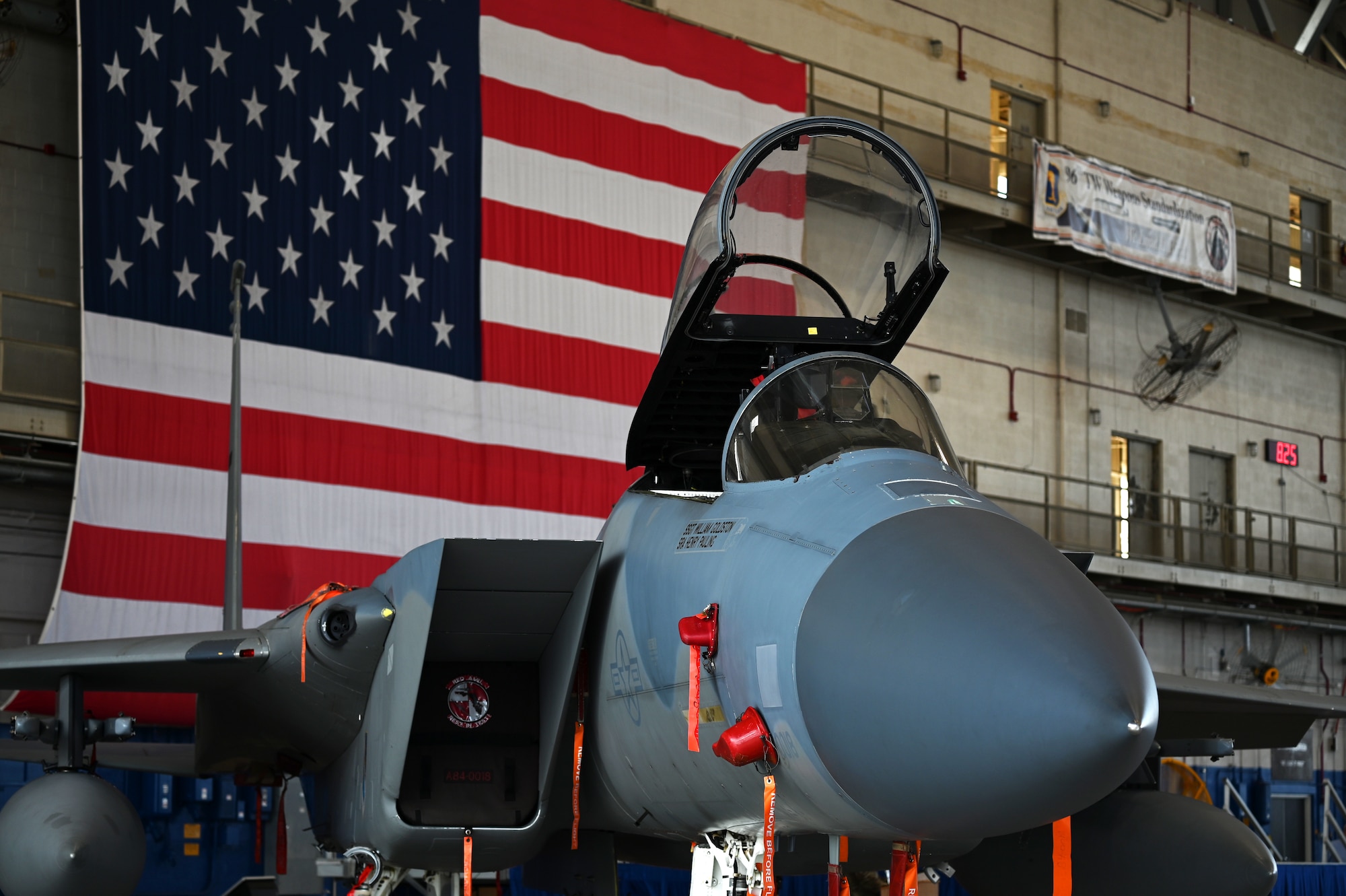 An F-15C Eagle sits in front of the U.S. Flag during a change of command ceremony for the 850th Spectrum Warfare Group at Eglin Air Force Base, Fla., June 23, 2023. The 850th SWG welcomed its second commander to the group, U.S. Air Force Col. Andrew Finkler. (U.S. Air Force photo by 1st Lt. Benjamin Aronson)