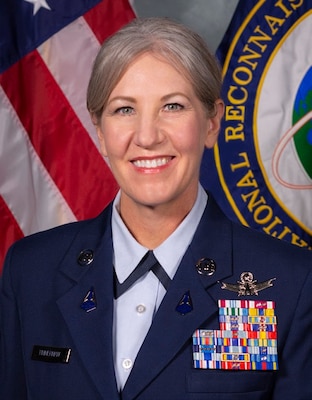 Headshot of Chief Master Sergeant Tina R. Timmerman, U.S. Space Force (USSF), command senior enlisted leader (CSEL), National Reconnaissance Office (NRO). She is wearing a blue Space Force uniform adorned with metals on her left breast pocket.