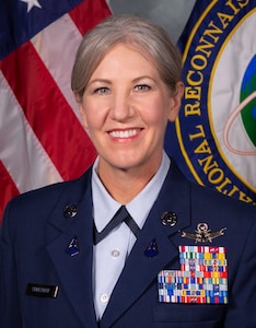 Headshot of Chief Master Sergeant Tina R. Timmerman, U.S. Space Force (USSF), command senior enlisted leader (CSEL), National Reconnaissance Office (NRO). She is wearing a blue Space Force uniform adorned with metals on her left breast pocket.