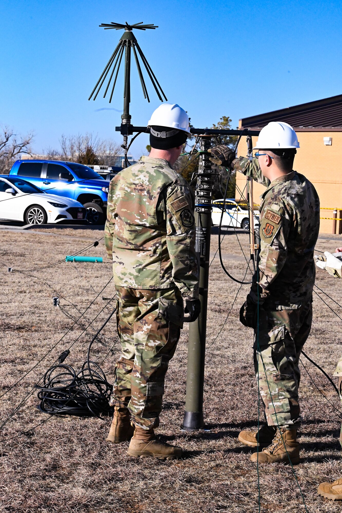 two people standing by an antenna