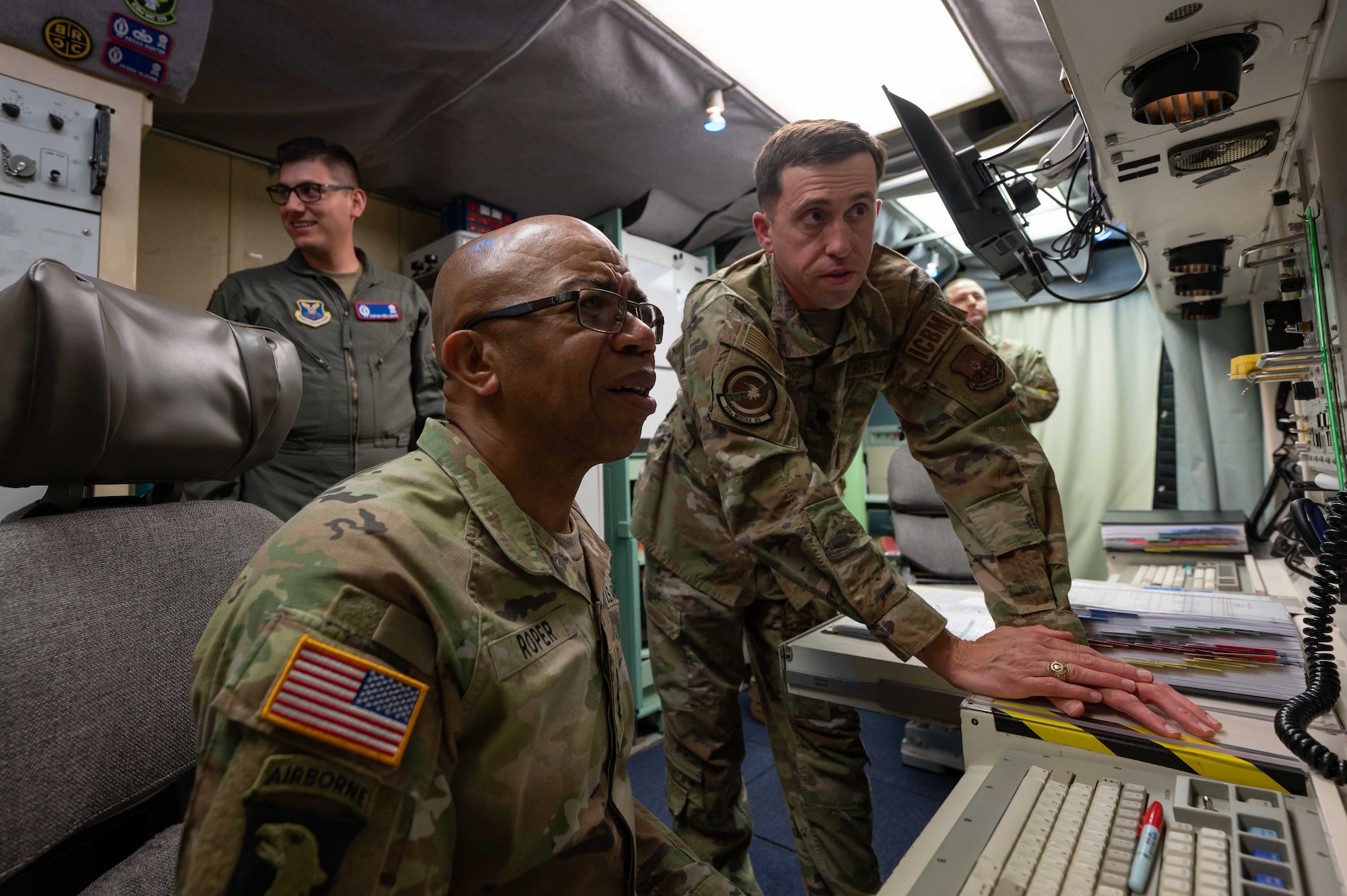 U.S. Air Force Lt. Col. Jared Bishop, 319th Missile Squadron commander, demonstrates to U.S. Army Lt. Gen. A.C. Roper, deputy commander of U.S. Northern Command, how launch control center computers operate at the Bravo-01 missile alert facility near Bushnell, Nebraska, June 13, 2023. Roper traveled to the 90th Missile Wing and missile field to better understand how a missile wing mission operates in support of homeland defense. (U.S. Air Force photo by Senior Airman Sarah Post)