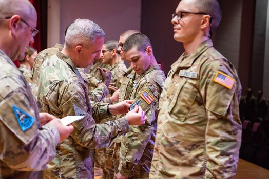  Lt. Gen. Stephen N. Whiting, Space Operations Command commander, places a patch on a Guardian during the U.S. Space Force patching ceremony at basic military training June 20, 2023.