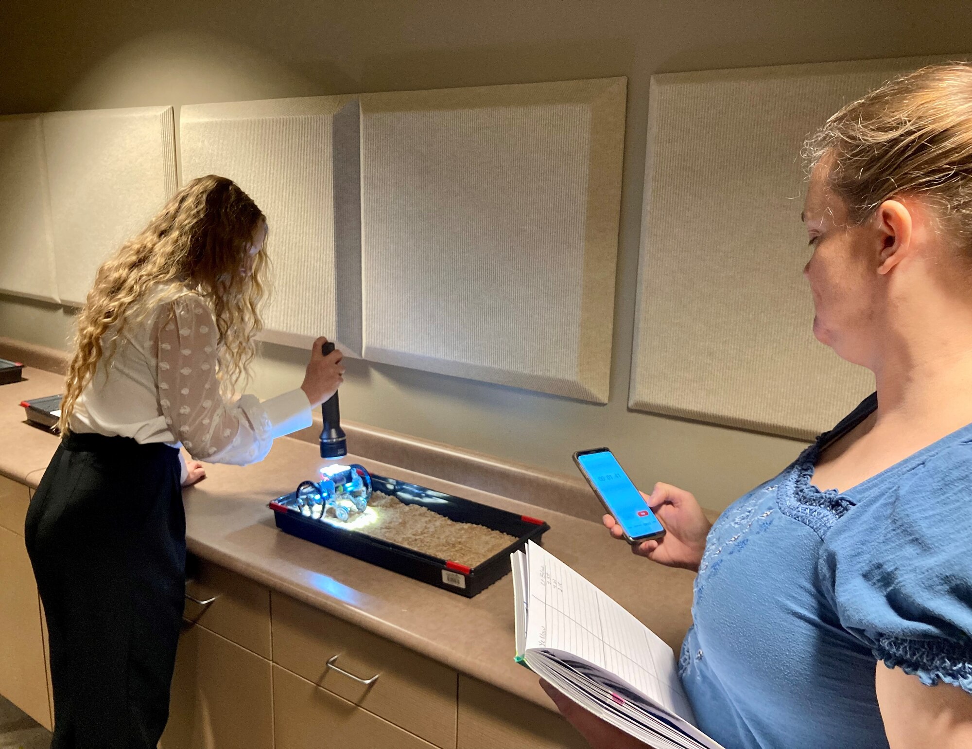 Kassidy Mikesell, Air Force Life Cycle Management Center intern, tests a solar robot on sand. Interns built robots as part of Foundational Botcamp, an educational course for new employees and interns that is designed primarily to help demonstrate and emphasize the importance of teamwork. (Courtesy photo)