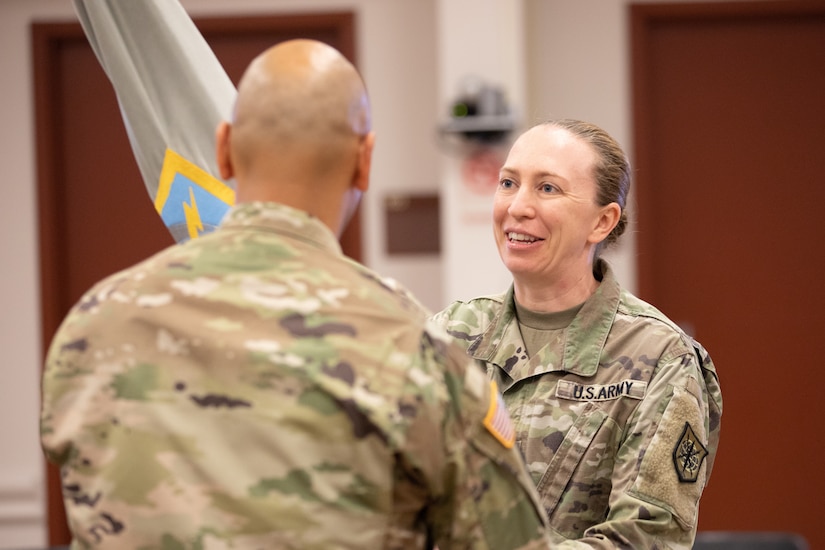 Lt. Col. Llexandra Landreth accepts the brigade colors from the unit command sergeant major.