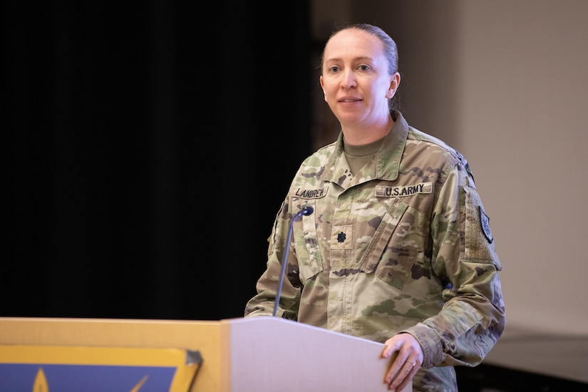 Lt. Col. Llexandra Landreth addresses the audience from a podium.