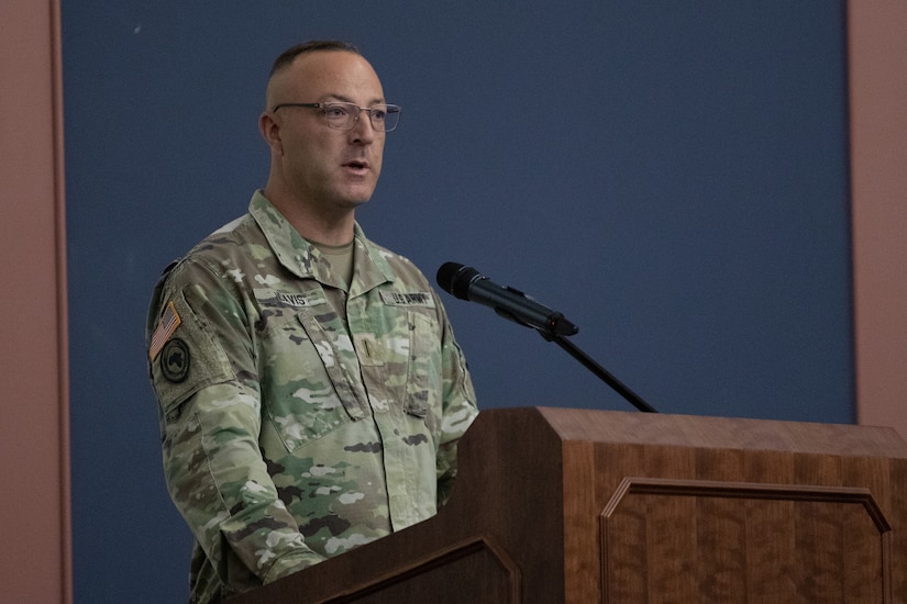Chief Warrant Officer 5 William Davis addresses the audience during a command chief warrant officer change of responsibility ceremony. He is standing at a podium.
