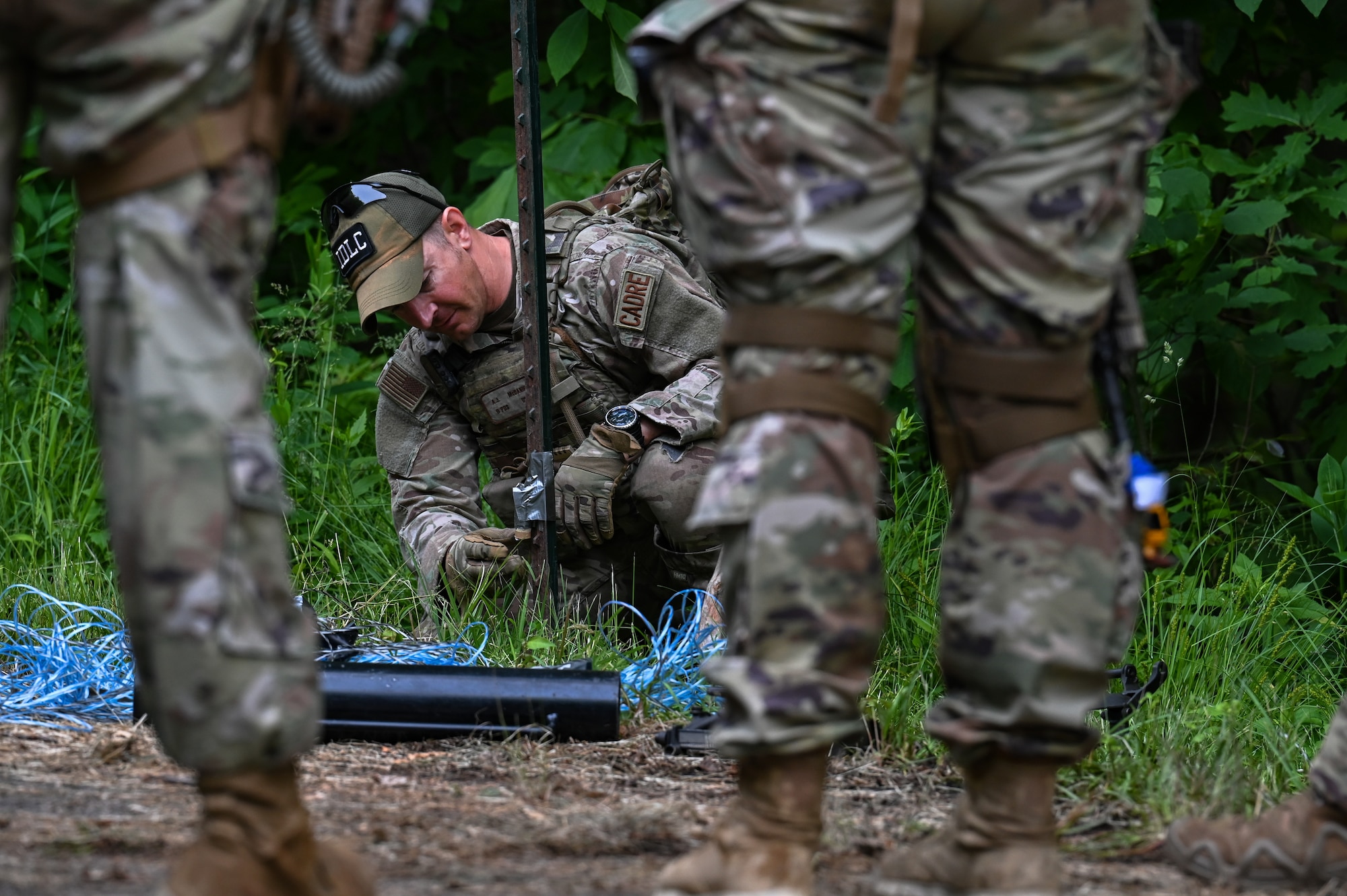 Tech. Sgt. Anthony McDaniel, an Integrated Defense Leadership Course cadre member assigned to the 914th Security Forces Squadron, Niagara Falls Air Reserve Station, New York, demonstrates how to set up an early warning device on June 15, 2023, at Camp James A. Garfield Joint Military Training Center, Ohio.