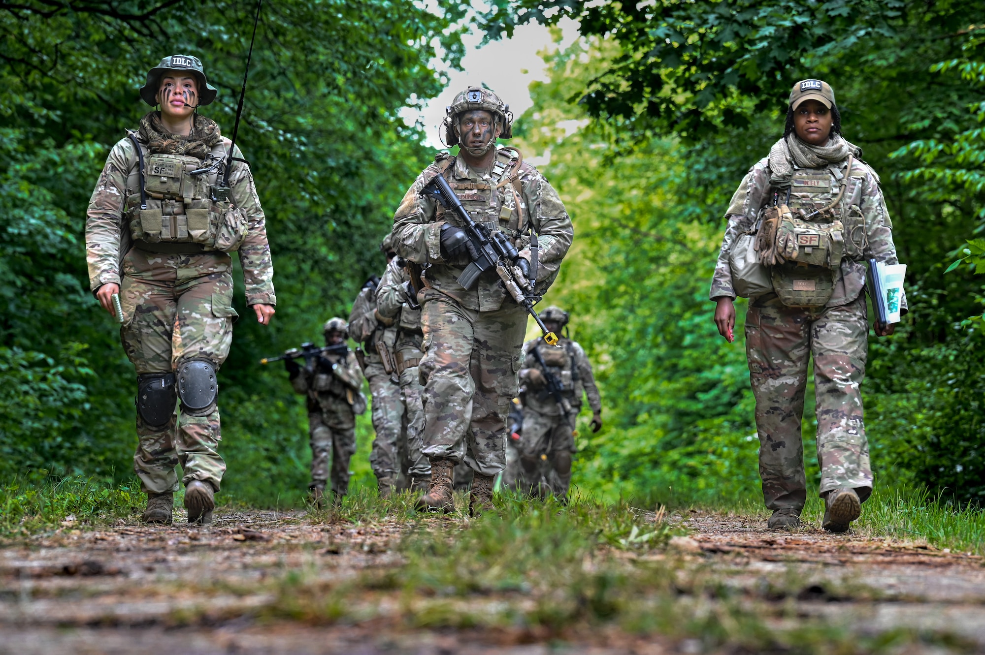Integrated Defense Leadership Course students assigned to the 301st Security Forces Squadron, Carswell Field, Naval Air Station Joint Reserve Base Fort Worth, Texas, begin to navigate their way through the woods to their objective on June 15, 2023, at Camp James A. Garfield Joint Military Training Center, Ohio, under the instruction of cadre members Tech. Sgt. Arica Sims and Tech. Sgt. Brionna Neely.