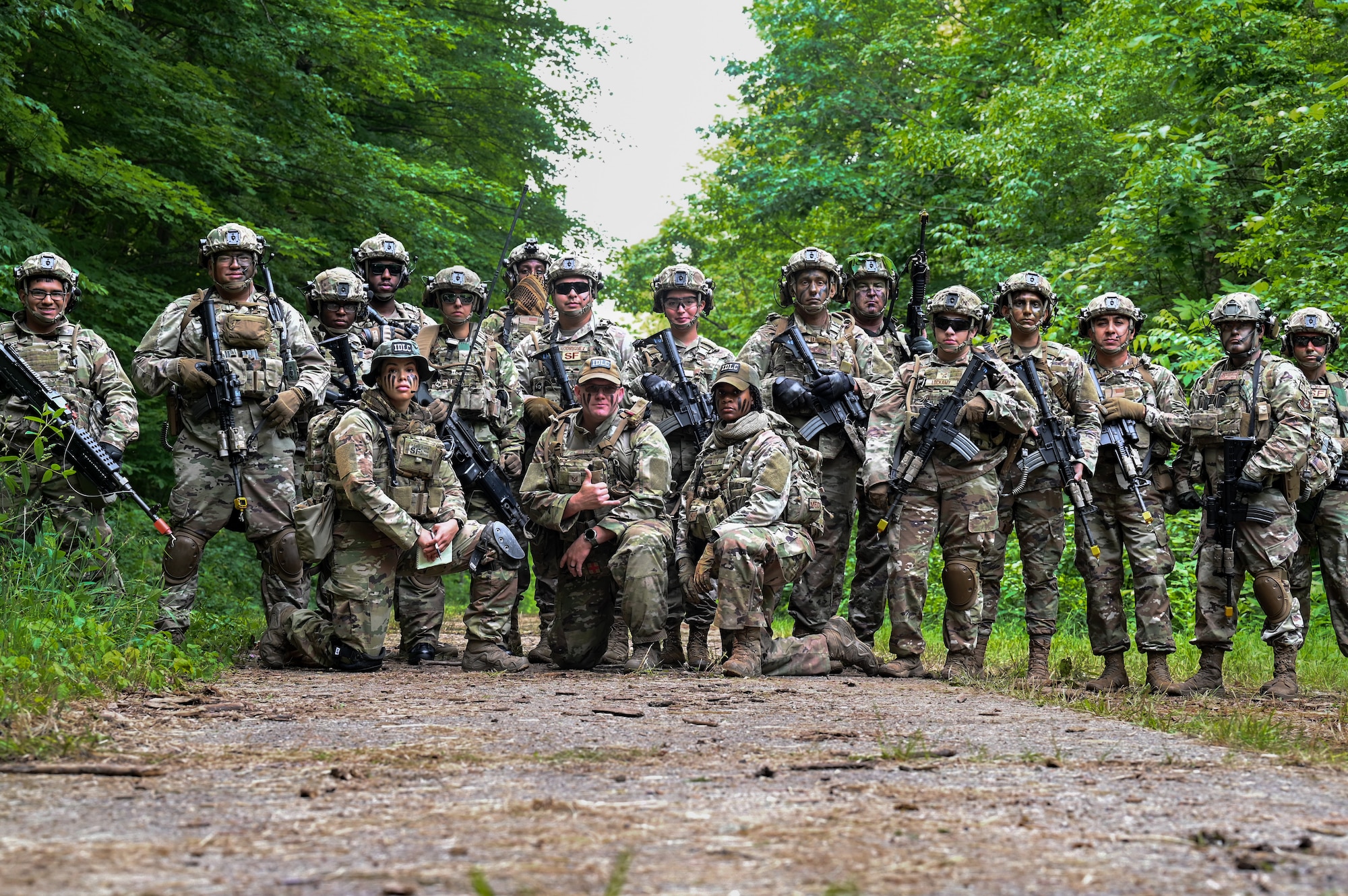 Integrated Defense Leadership Course cadre members and Defenders assigned to the 301st Security Forces Squadron, Carswell Field, Naval Air Station Joint Reserve Base Fort Worth, Texas, pause for a photo at the beginning of an area security operations exercise on June 15, 2023, at Camp James A. Garfield Joint Military Training Center, Ohio.