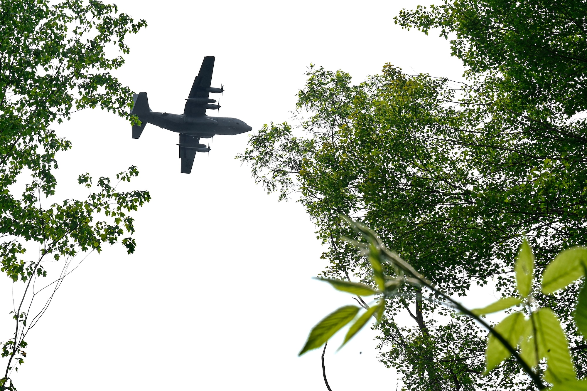 A C-130H Hercules aircraft assigned to the 757th Airlift Squadron flies over a training exercise on June 15, 2023, at Camp James A. Garfield Joint Military Training Center, Ohio.