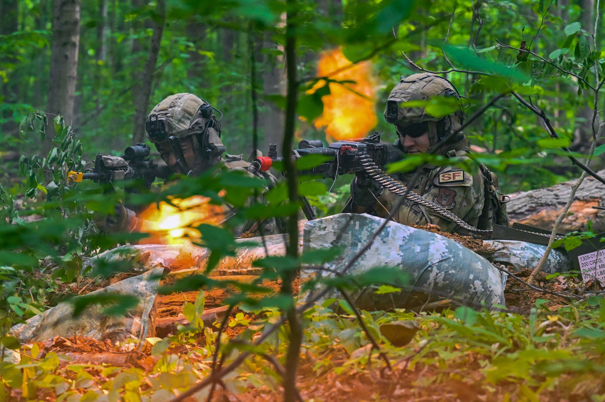 Defenders assigned to the 301st Security Forces Squadron, Carswell Field, Naval Air Station Joint Reserve Base Fort Worth, Texas, fire the M4 carbine and M249 light machine gun during a training exercise on June 15, 2023, at Camp James A. Garfield Joint Military Training Center, Ohio.
