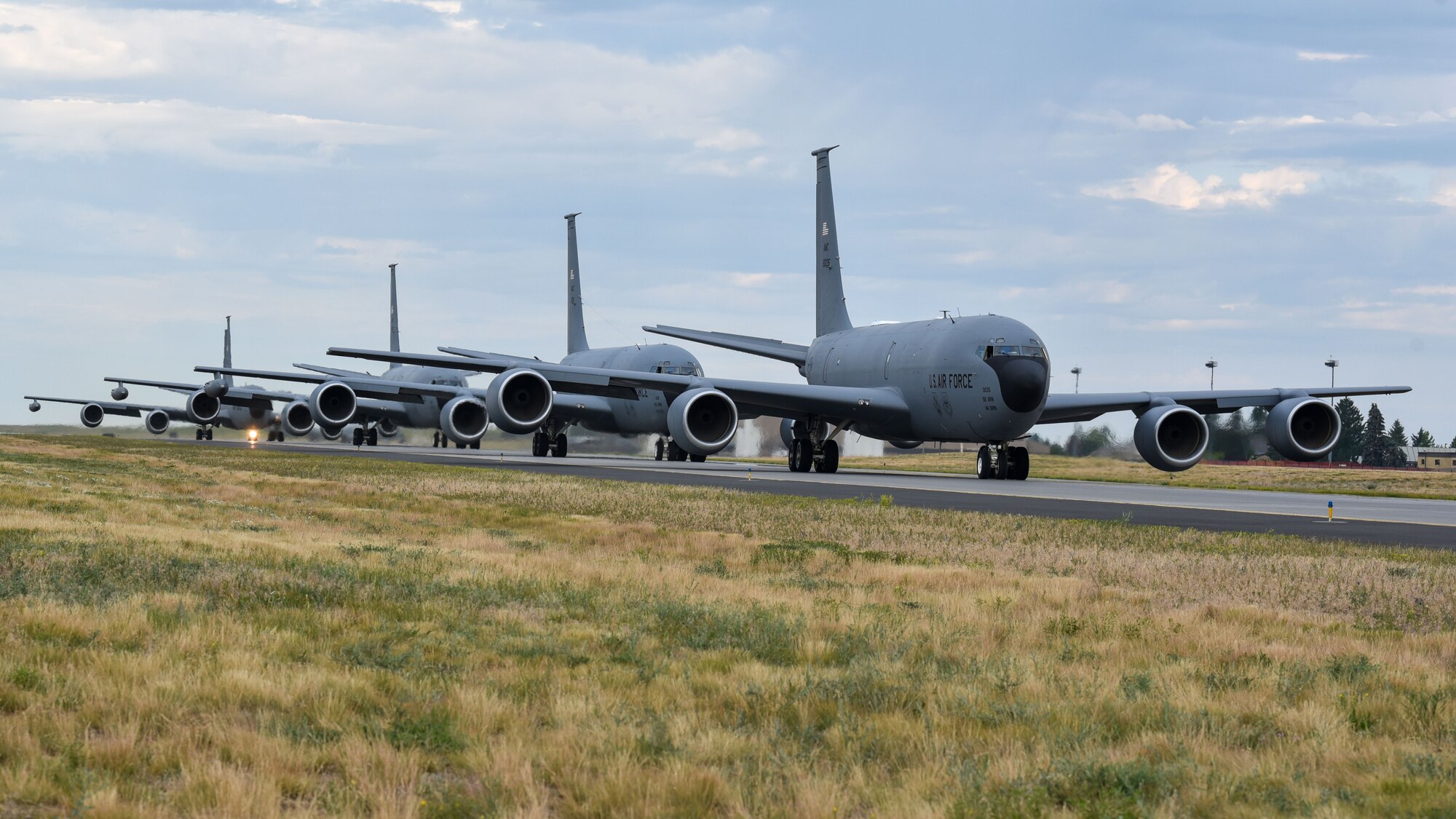 KC-135 Stratotankers assigned to the 92nd Air Refueling Wing and 141st Air Refueling Wing taxi into position before takeoff  as part of Operation Centennial Contact at Fairchild Air force Base, Washington, June 27, 2023. The movement, which included stops at Yellowstone National Park, Mount Rushmore and Glacier National Park, was part of Air Mobility Command’s celebration of 100 years air refueling operations and demonstrated the 92nd Air Refueling Wing’s global reach capabilities. Since its inception in 1923, Air refueling has become a crucial component of military and civilian aviation operations around the world by extending the range and endurance of aircraft and enabling them to complete missions that would otherwise be impossible or require multiple stops. As a result, this capability is essential for strategic and tactical operations, as well as humanitarian relief efforts in support of AMC, U.S. Transportation Command and Department of Defense priorities. (U.S. Air Force photo by Airman 1st Class Lillian Patterson)