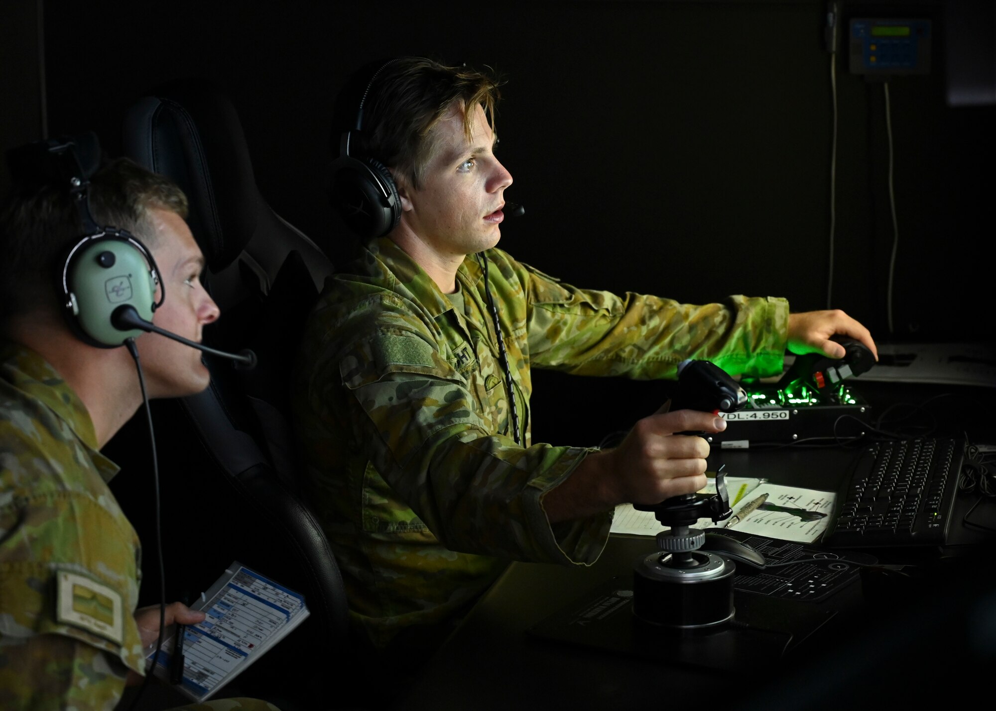 Australian Army Lance Bombardier Jack Ruff, with the 8th/12th Regiment, Royal Australian Artillery, left, and Bombardier Ben Roadnight, Joint Terminal Attack Controller Troop, operate a strike aircraft simulator at Joint Base Lewis-McChord, Washington, June 8, 2023. Members of the Australian Army spent the week visiting the 5th Air Support Operations Squadron training in the simulator to maintain currency in calling for close air support. (U.S. Air Force Senior Airman Callie Norton)