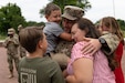 Staff. Sgt Michael Kadlec and his family reunite at the 18th Financial Support Center redeployment ceremony in front of Fowler Hall on Fort Knox, Kentucky, June 23, 2023.