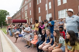 Family and Friends of the 1st Theater Sustainment Command wait anxiously for their Soldiers from the 18th Financial Support Center to be released from formation during a redeployment ceremony in front of Fowler Hall on Fort Knox, Kentucky, June 23, 2023.